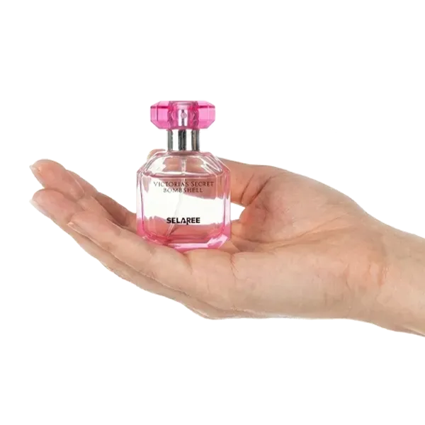 Hand holding miniature victoria secret bombshell